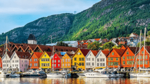 Vibrant houses along the water in Børenga, Norway, highlight the picturesque landscape ideal for cruise travellers